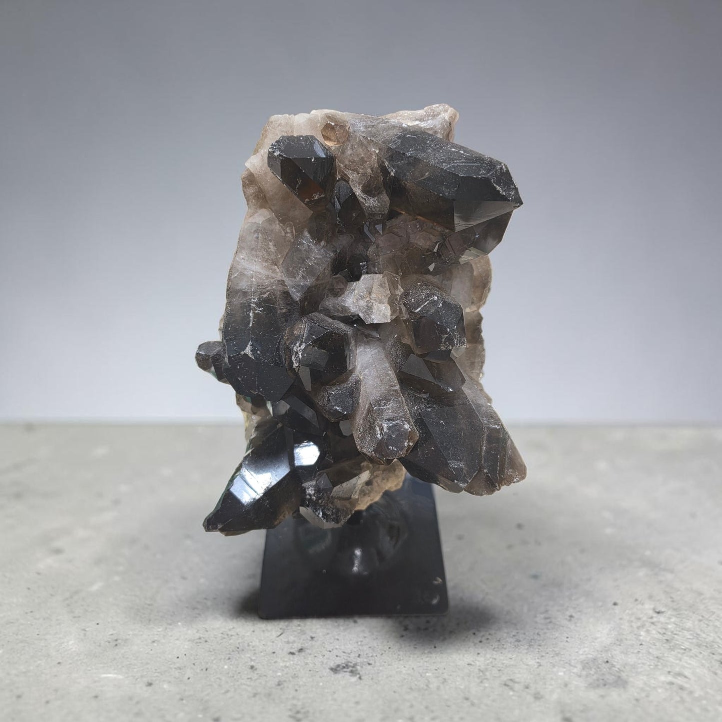 Huge raw smokey quartz on stand