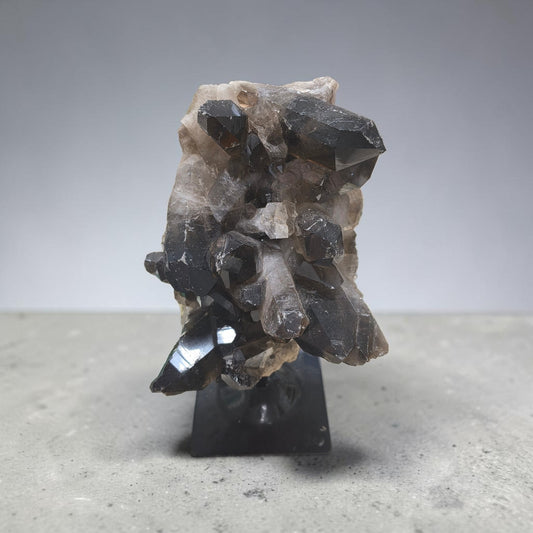 Huge raw smokey quartz on stand